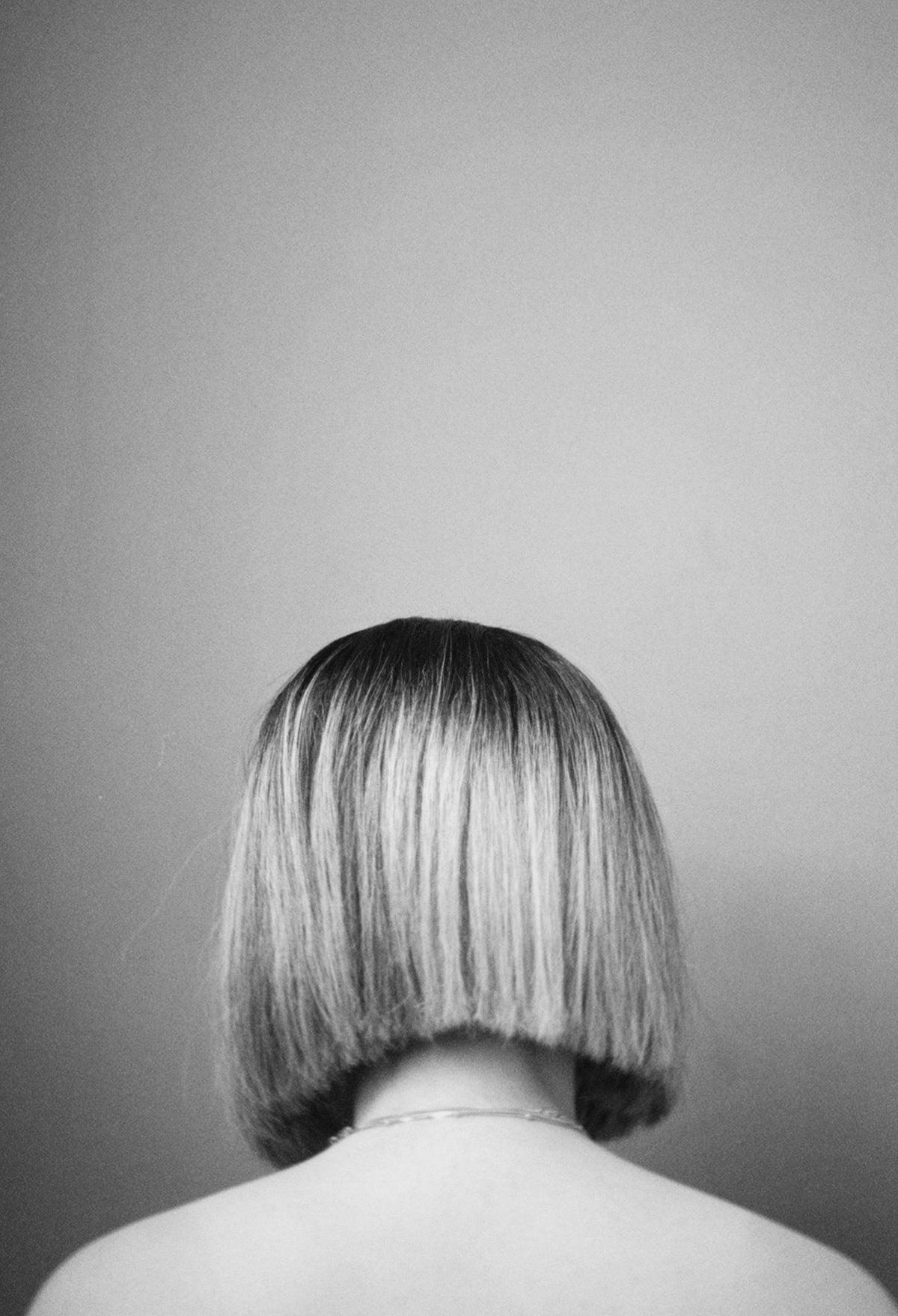 a black and white photo of a woman with short hair